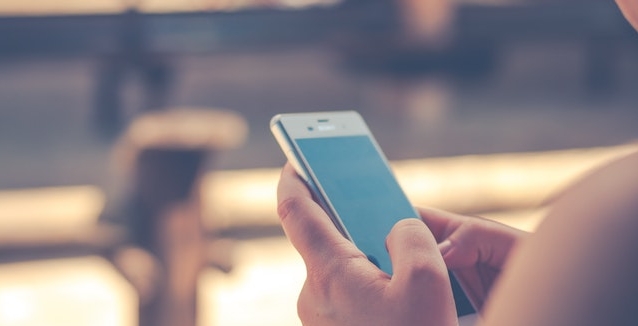 A woman holding a phone